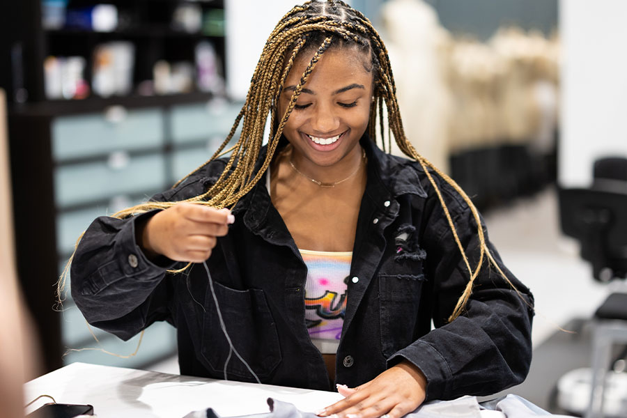 ksu arts student working on a costume.