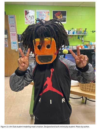  / Art Club student modeling a mask he decided to create. Creating opportunities for autonomy turbo-charges the student's development of independence, creativity, problem-solving and executive functioning skills, and more.