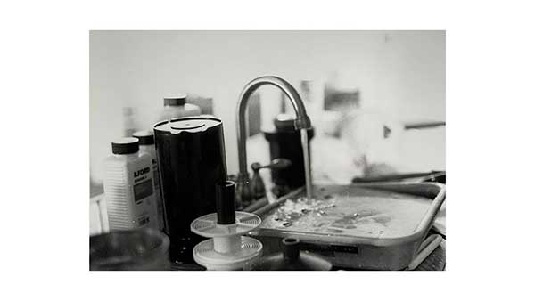  / Still life showcasing the washing of prints and the tools needed for the process of film photography