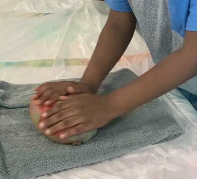  / Still photograph of student during felting process for vessel.
