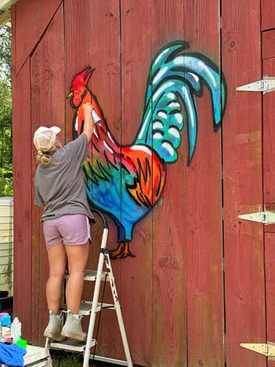  / Still of Katelin Richardson creating a sanctioned personal graffiti project after researching graffiti. 
