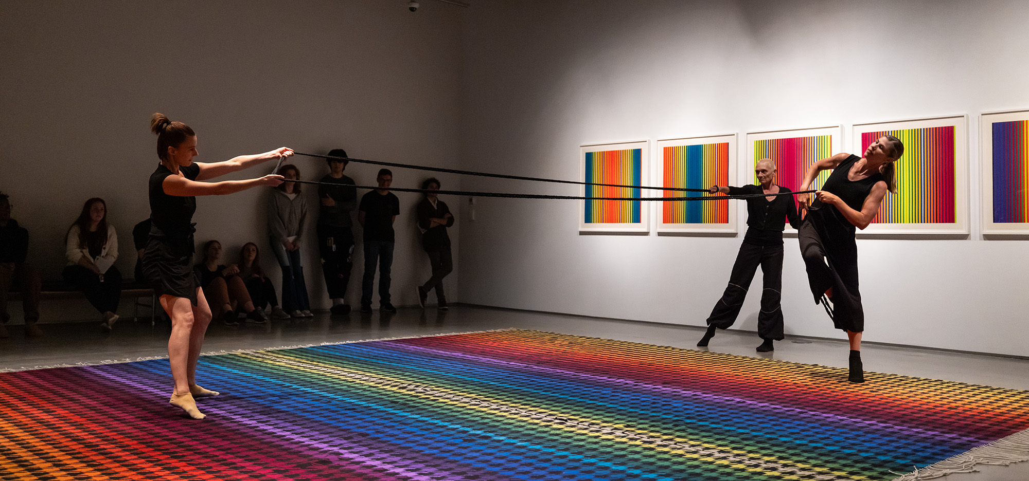 image of women dancing on top of a colorful rug