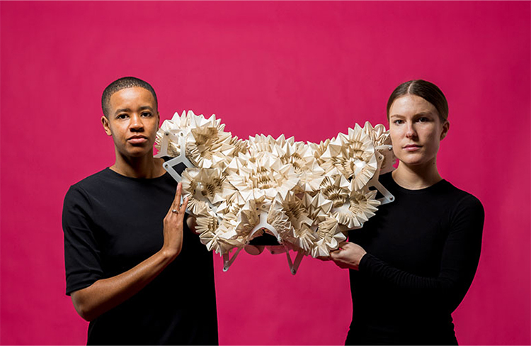 two females holding a construction