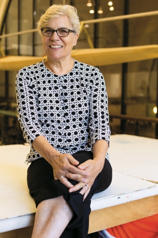 Annet Couwenberg sitting on table