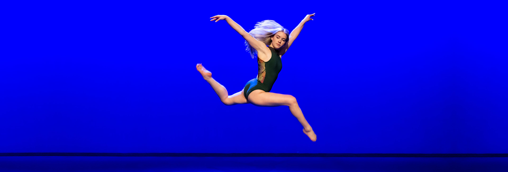 image of woman with gray hair leaping into the air