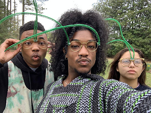 three male students wearing glasses on their green antennae