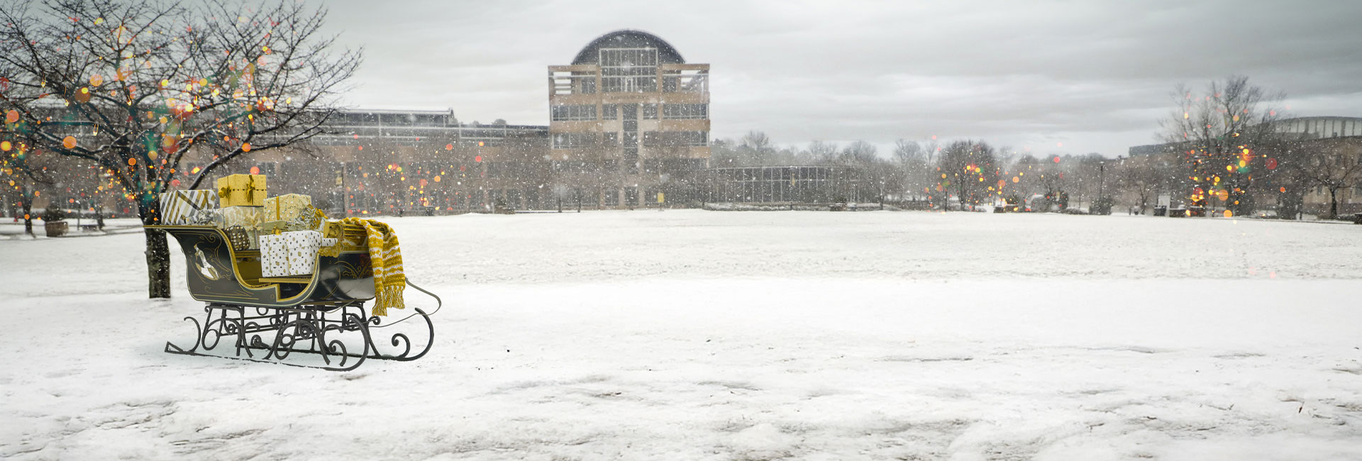 snowy campus green with kennesaw hall in the background and sleigh in the foreground