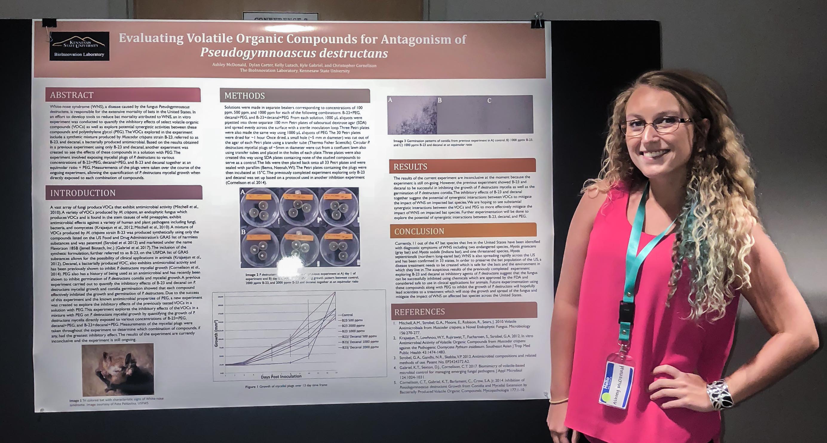 university undergraduate student  Ashley McDonald  next to her poster