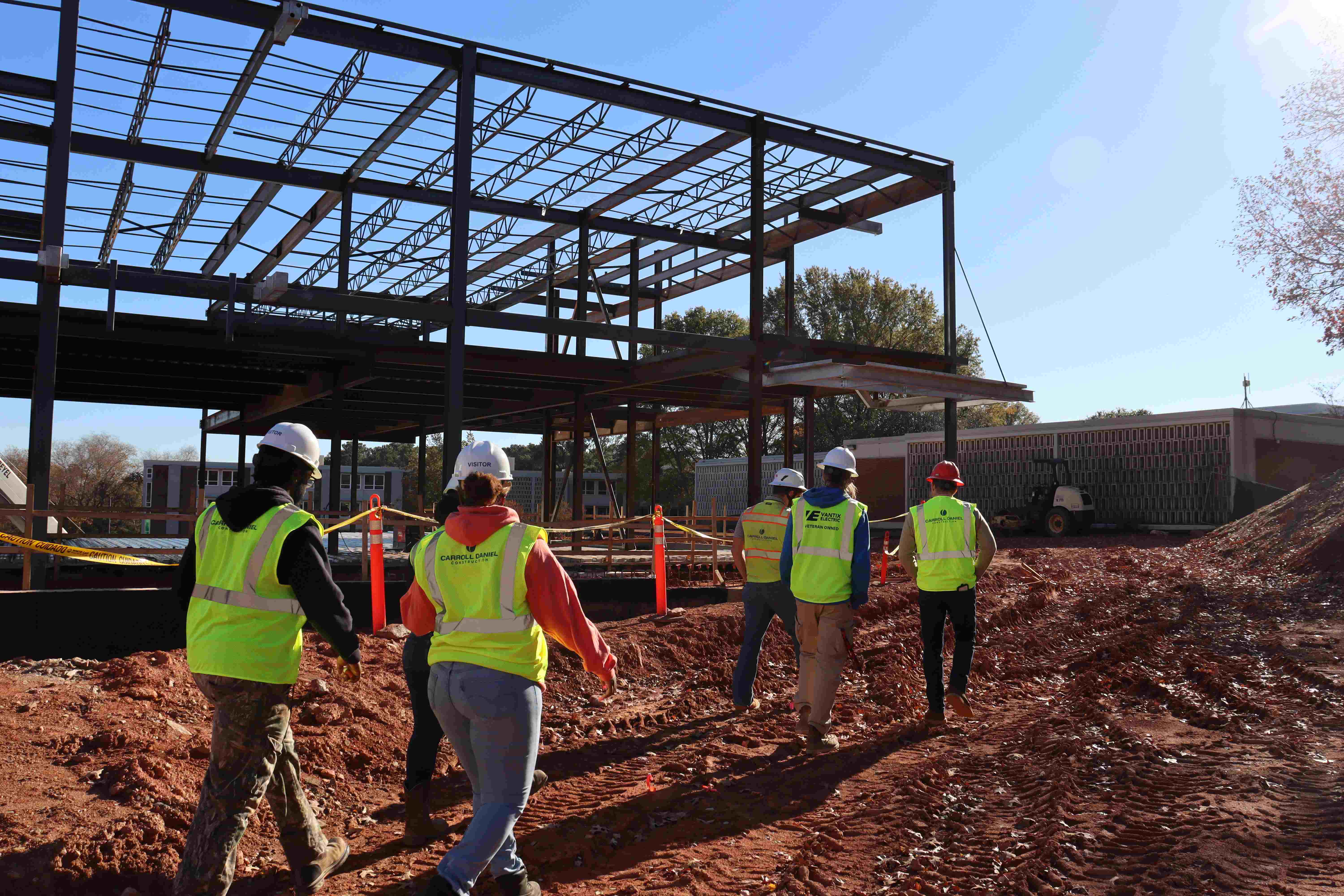 Construction Management students walk around a job site.