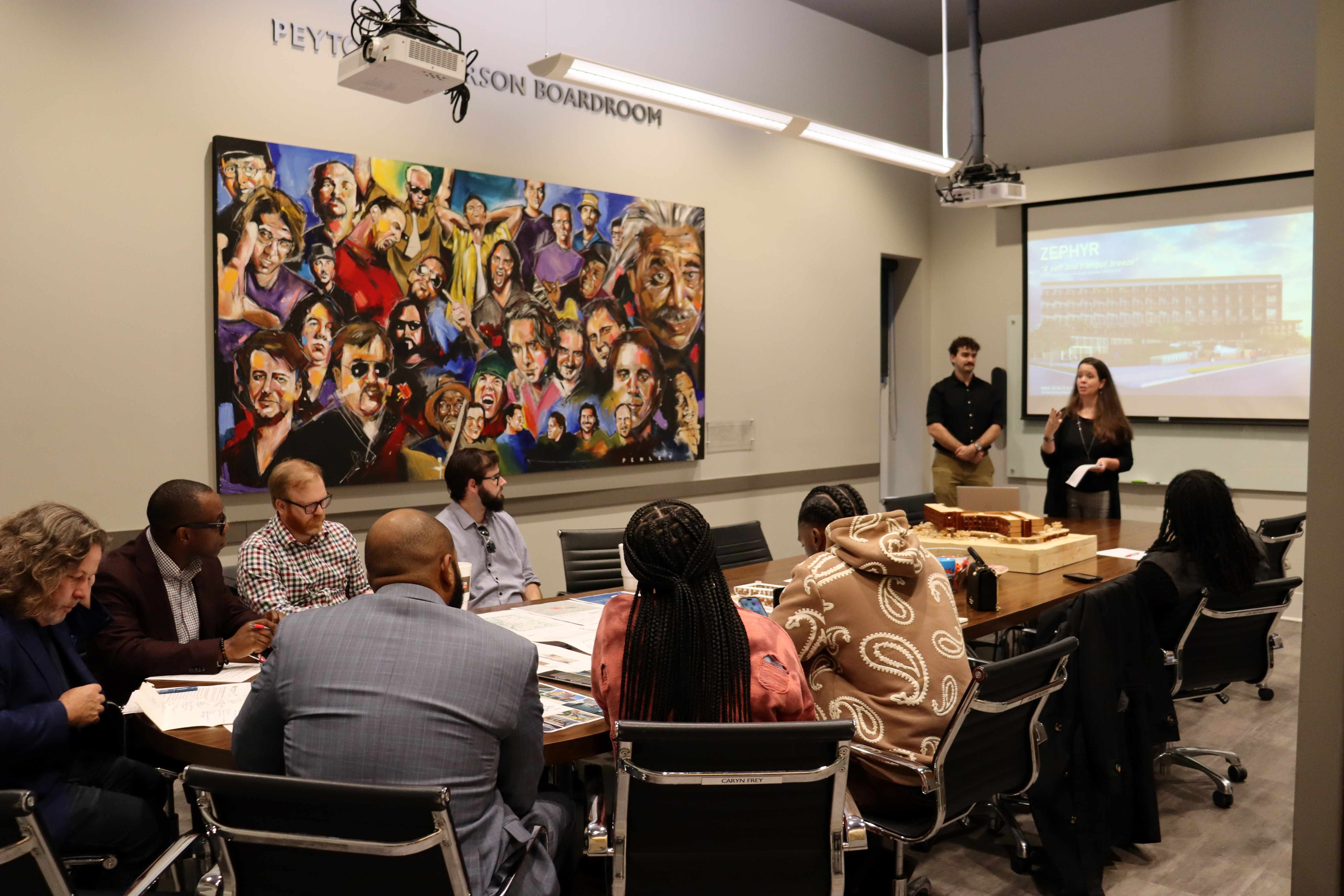 People gathered around a conference room table. 