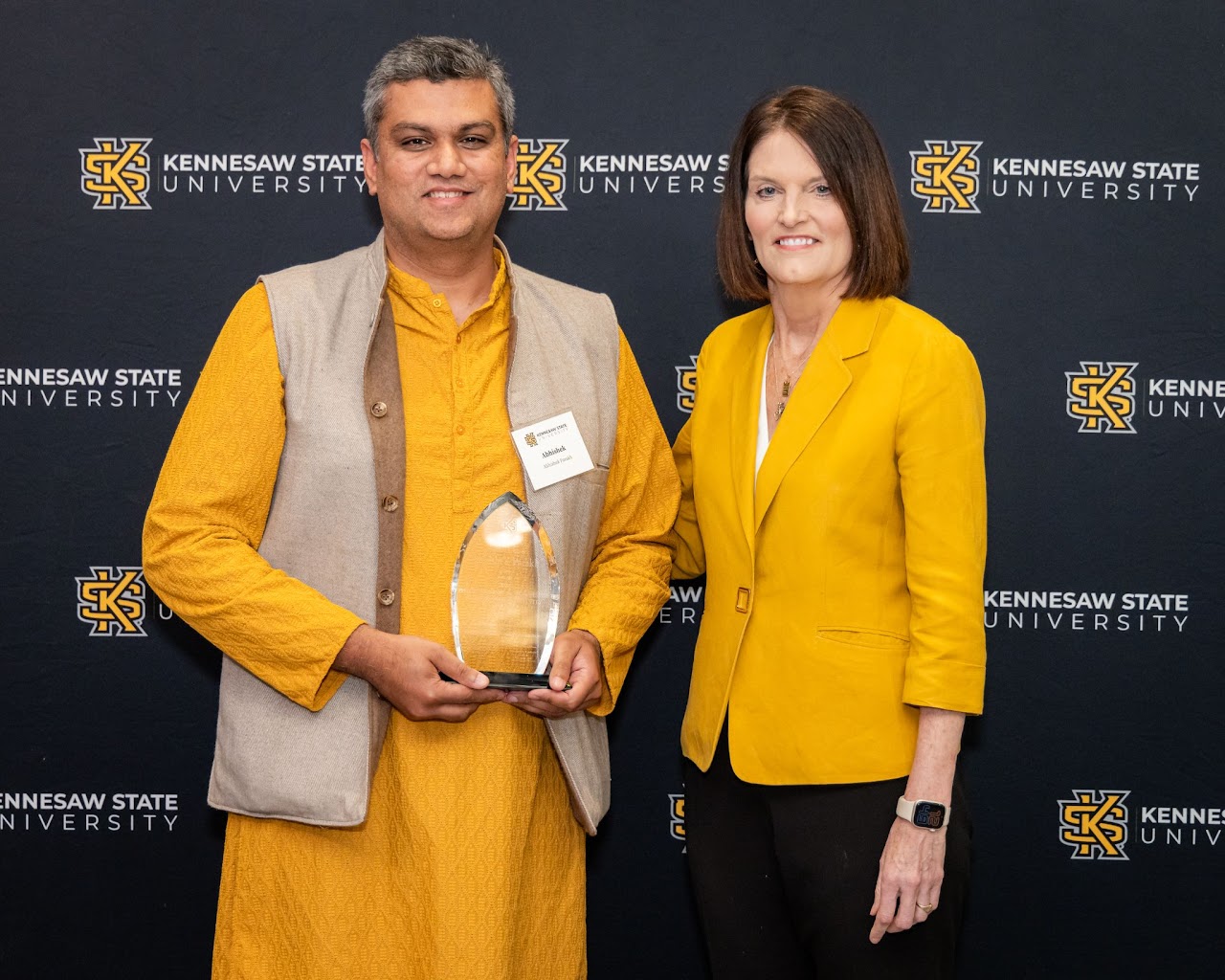 Dr. Abhishek Parakh accepts the 2024 KSU Faculty Award from university president Kathy Schweig.