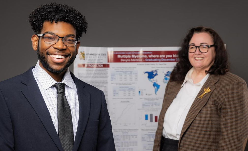 Desyne Martinez and Dr. Susan Hardy in front of a project poster