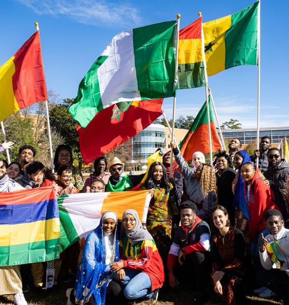 A picture of a group of international students with their flags
