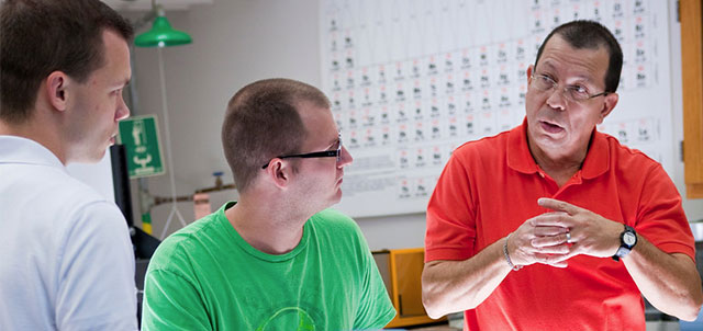 two students listening to a professor