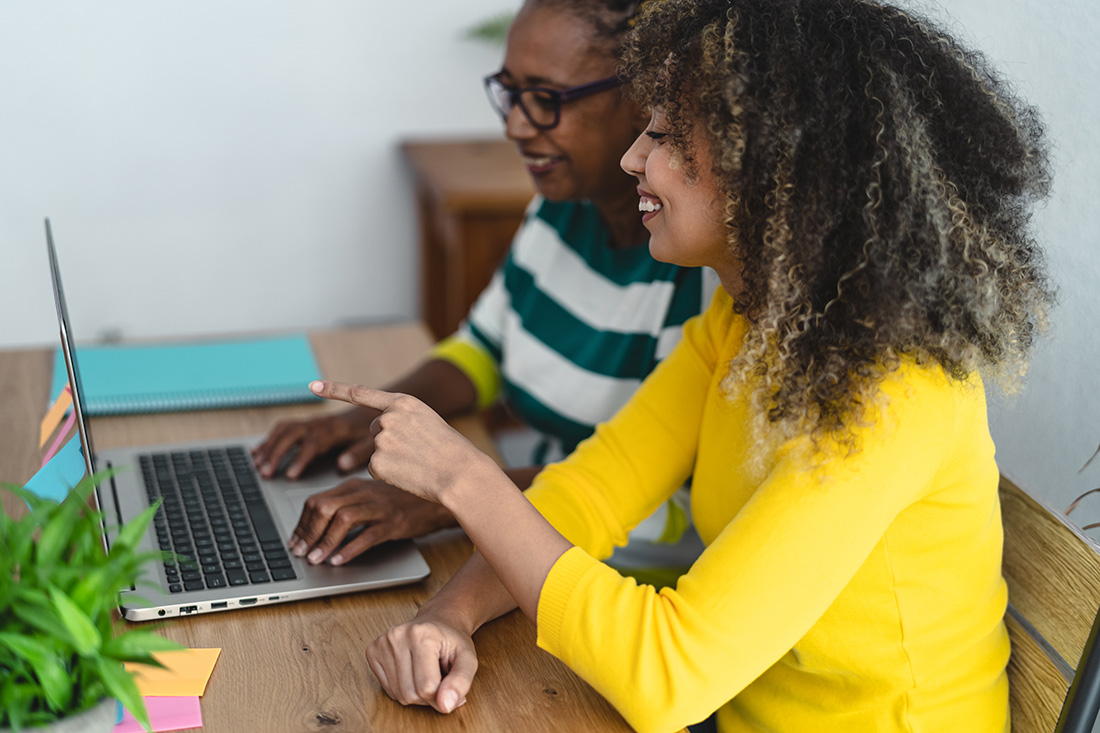 two women working at a computer