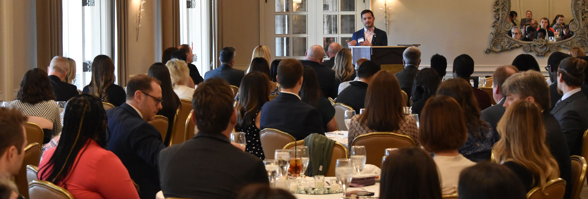 A crowded room with one of Cole's many business leaders as the guest speaker.