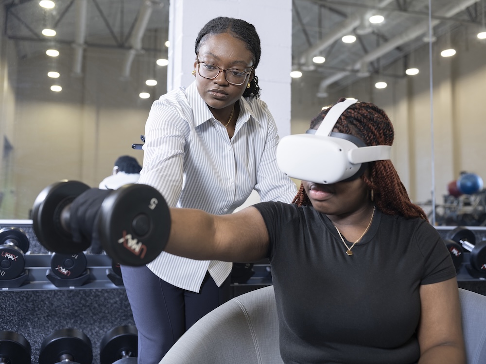 photo of Fareedah Ashiru working with virtual reality