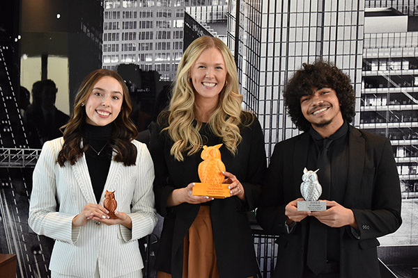 photo of three KSU students and their trophies.