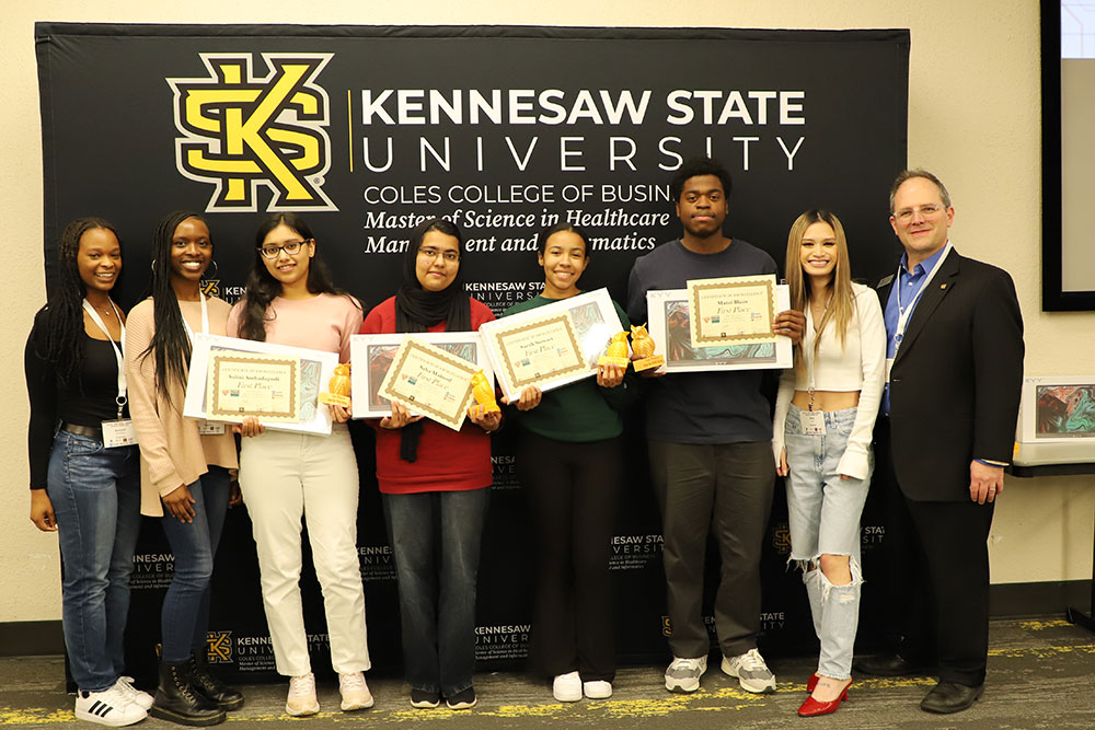 Winning team of students at the hackathon posing with their certificates