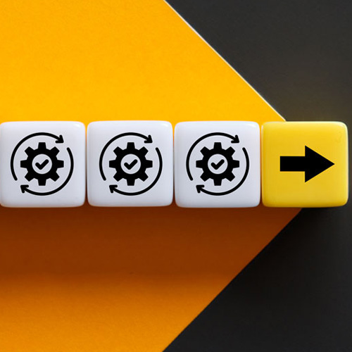 Three white dice with gear symbols and a yellow arrow pointing to the right. The dice are on a black and gold background.