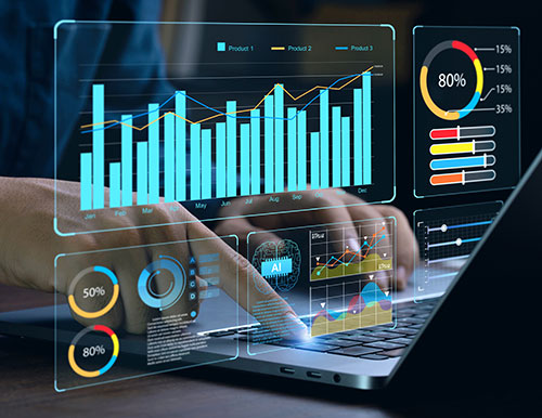 A person's hands interacting with a laptop, with various data visualizations and charts appearing on the screen, including bar graphs, pie charts, and line graphs. The word "AI" is visible, suggesting the use of artificial intelligence in data analysis.