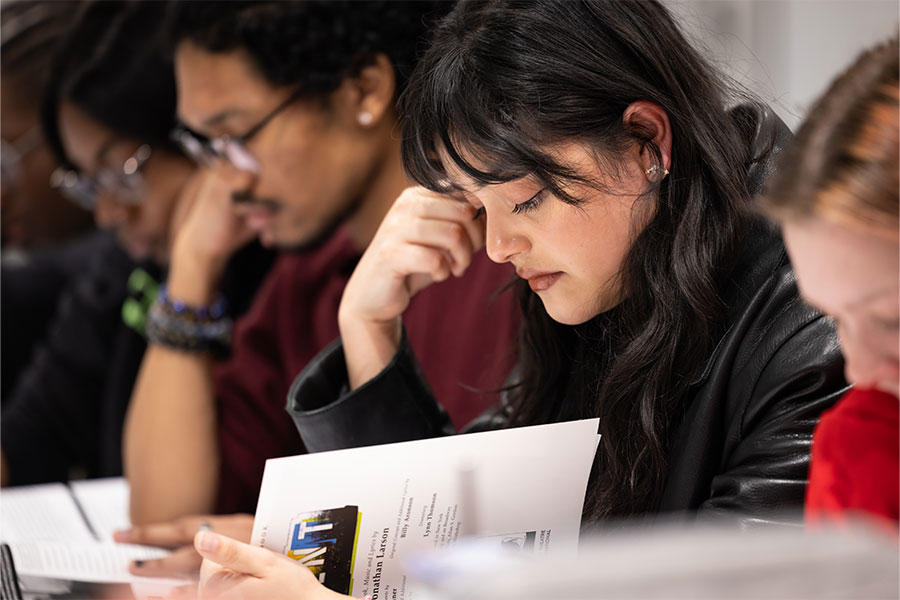 group of ksu students reading paperwork.