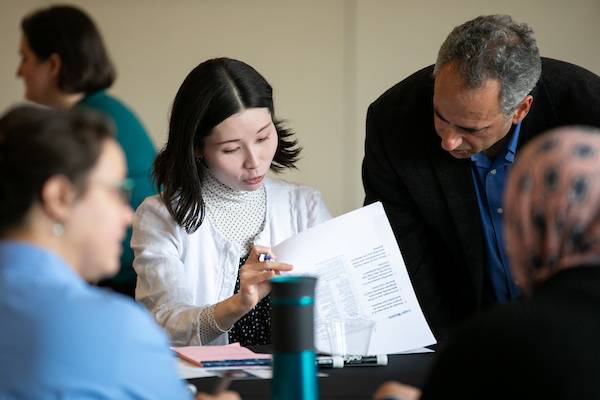 ksu student showing their professor their paper.