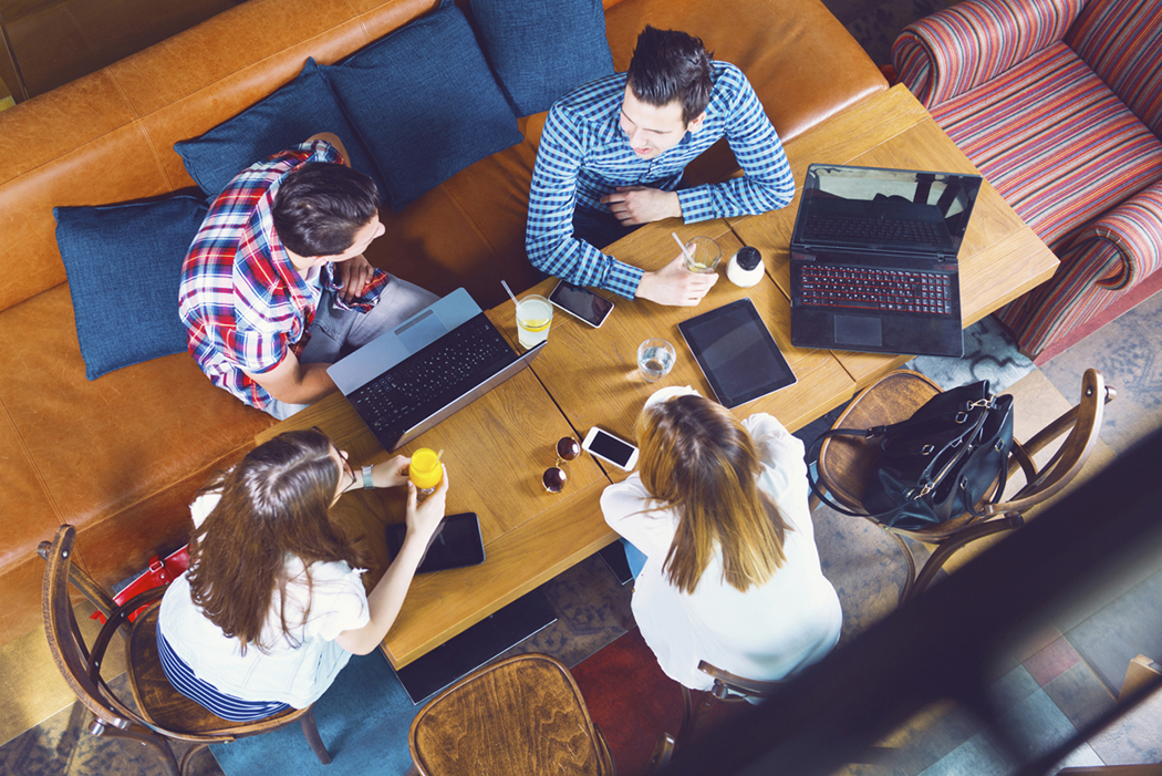 group working together with laptops on a table