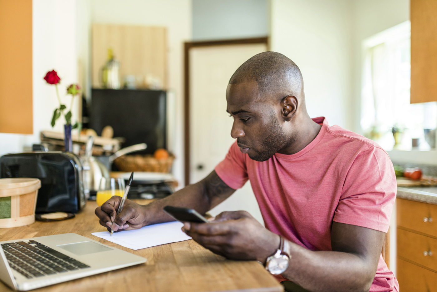 man using laptop in kitchen