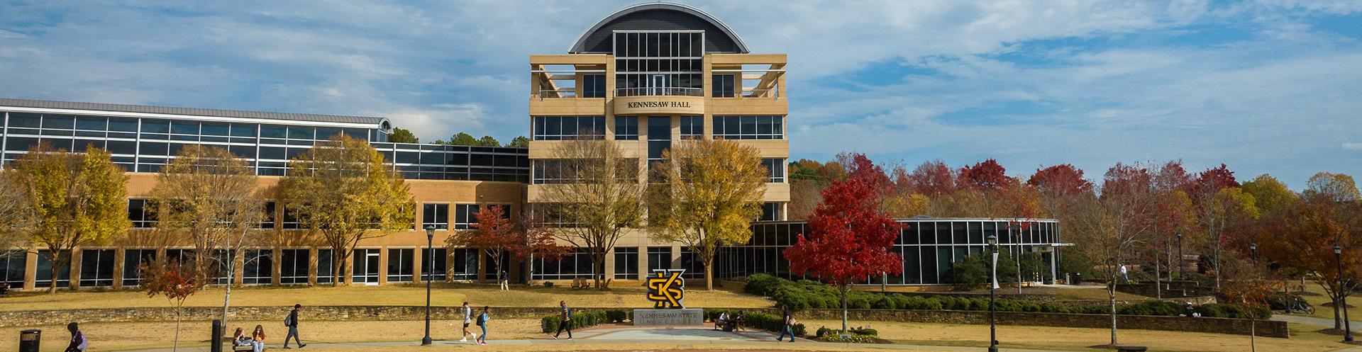 KSU campus adorned in vibrant fall colors, showcasing Kennesaw Hall in the background.