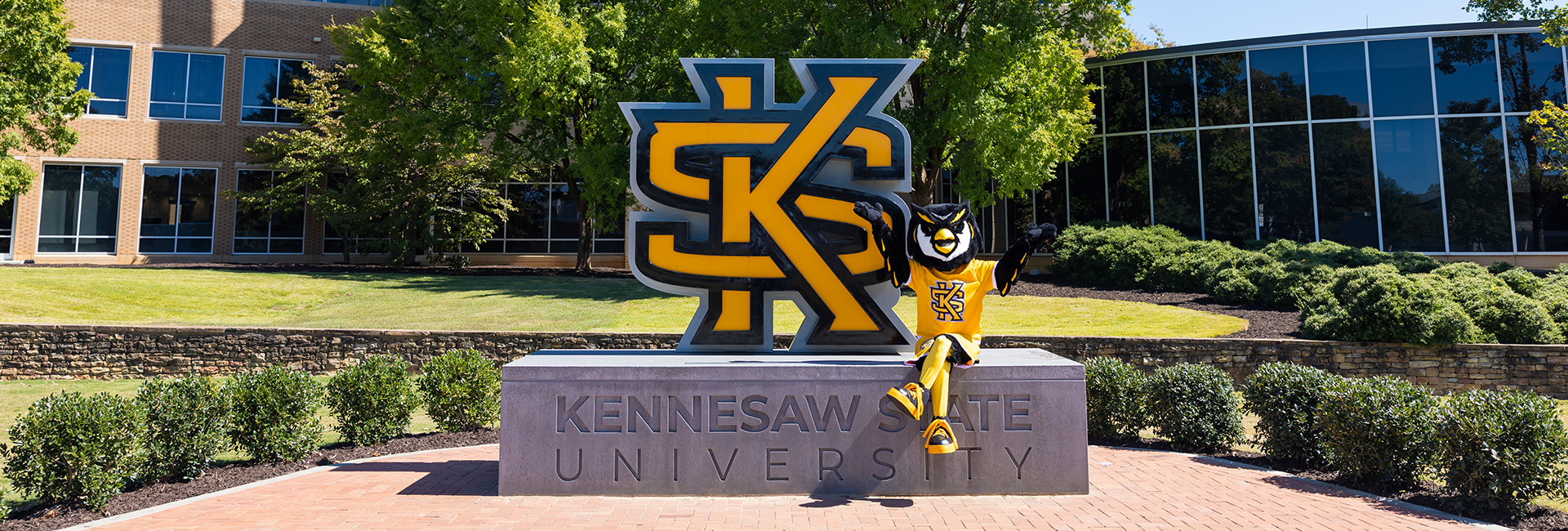 Scrappy in front of a Kennesaw State University monument