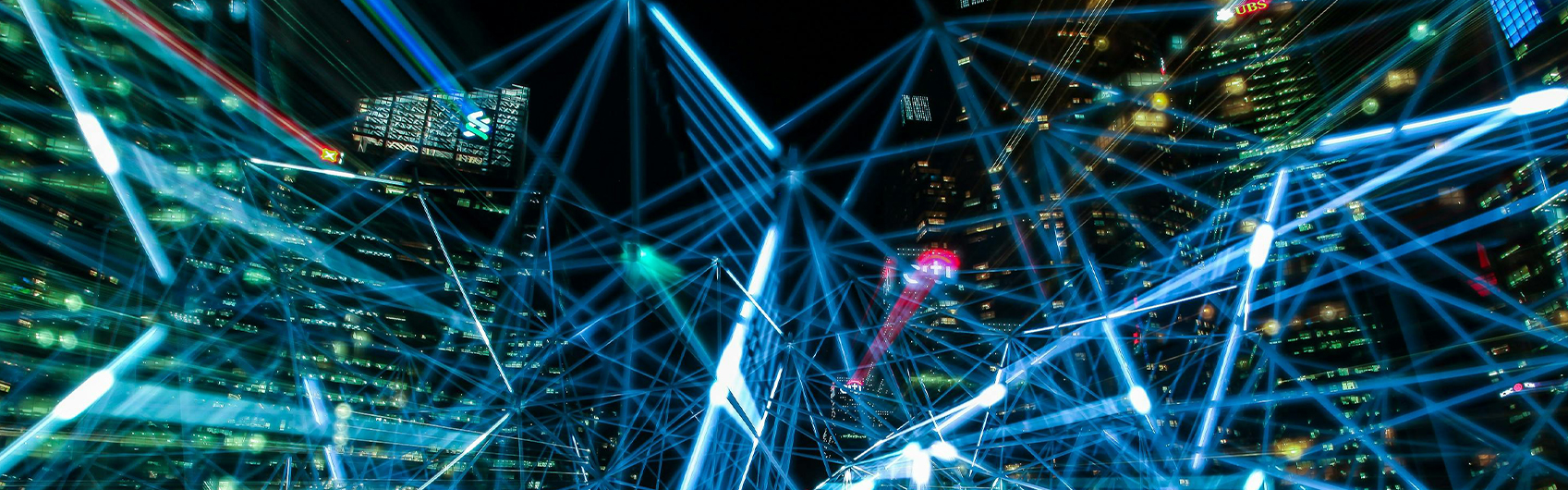 A visualization of an AI neural network overlayed over a photo of skyscrapers in a city at night