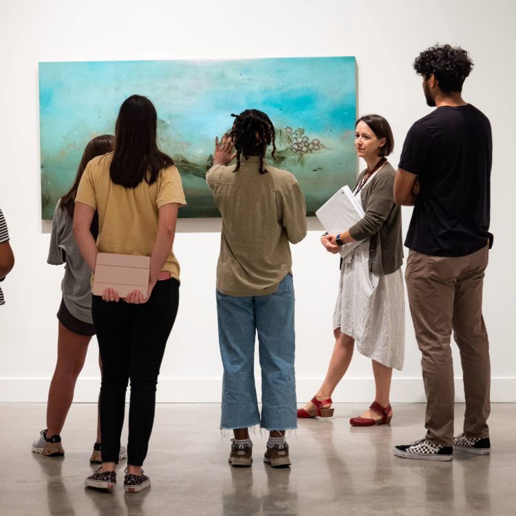 students studying artwork in museum with an instructor