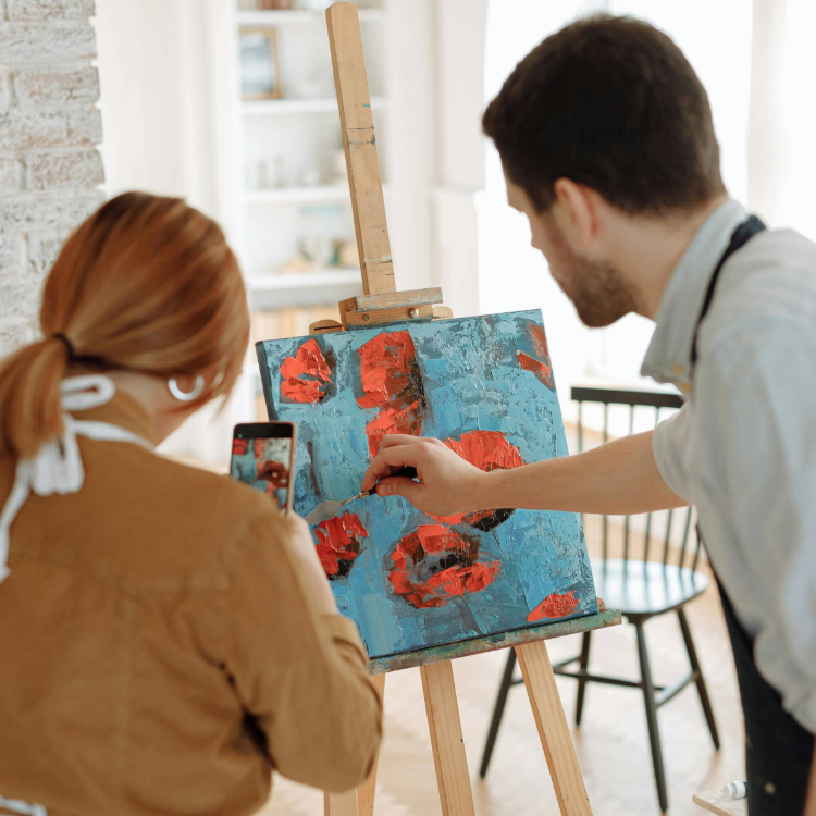 art education teacher instructing student how to paint