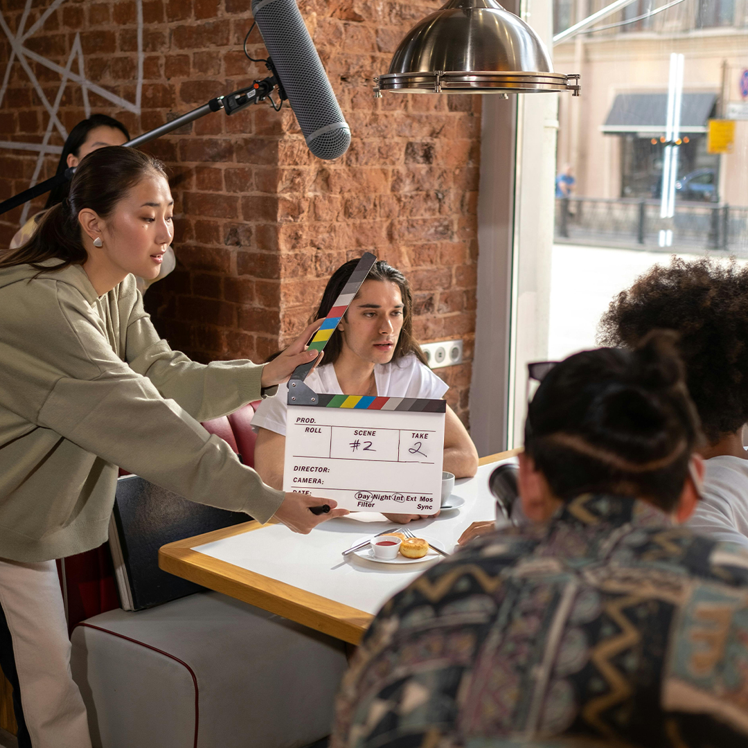 student filmmakers on set of indie short film in a dining set