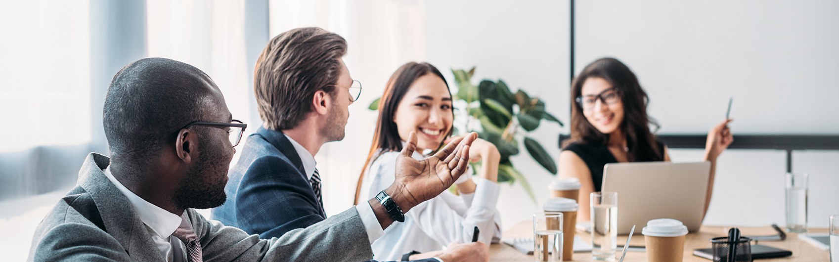 office coworker smiling and brainstorming in meeting