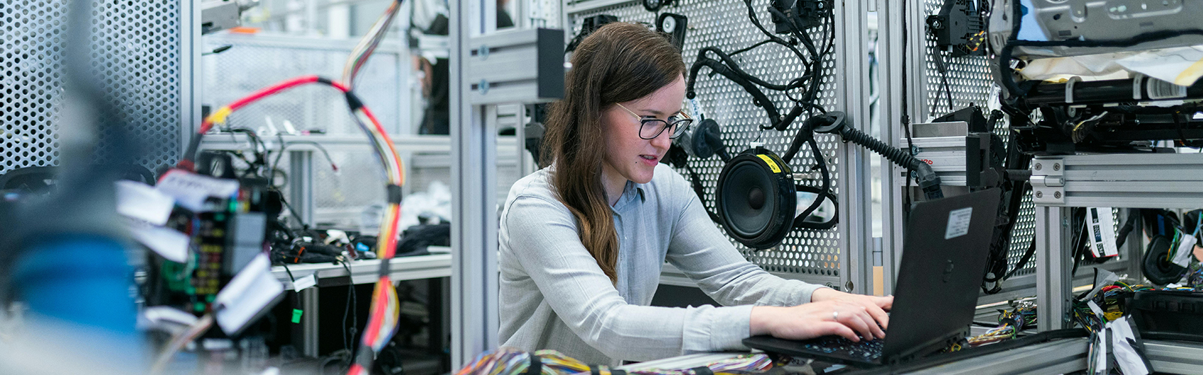 A female software engineer typing on computer in computing lab center