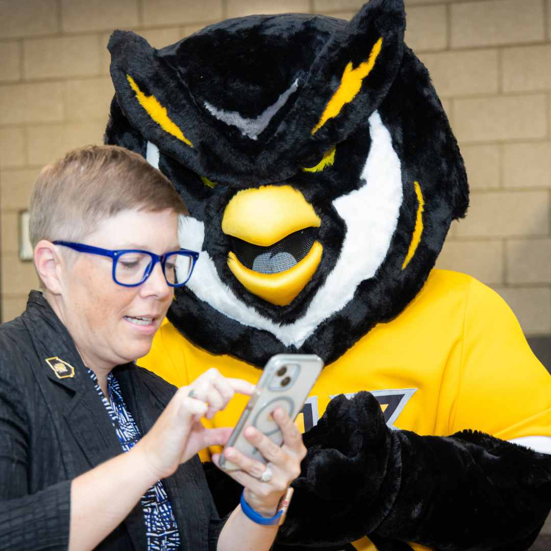 KSU's scrappy looking at phone