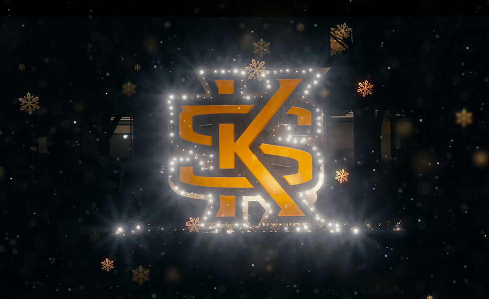 Kennesaw State University logo outlined in white holiday lists on a black background accented with gold snowflakes