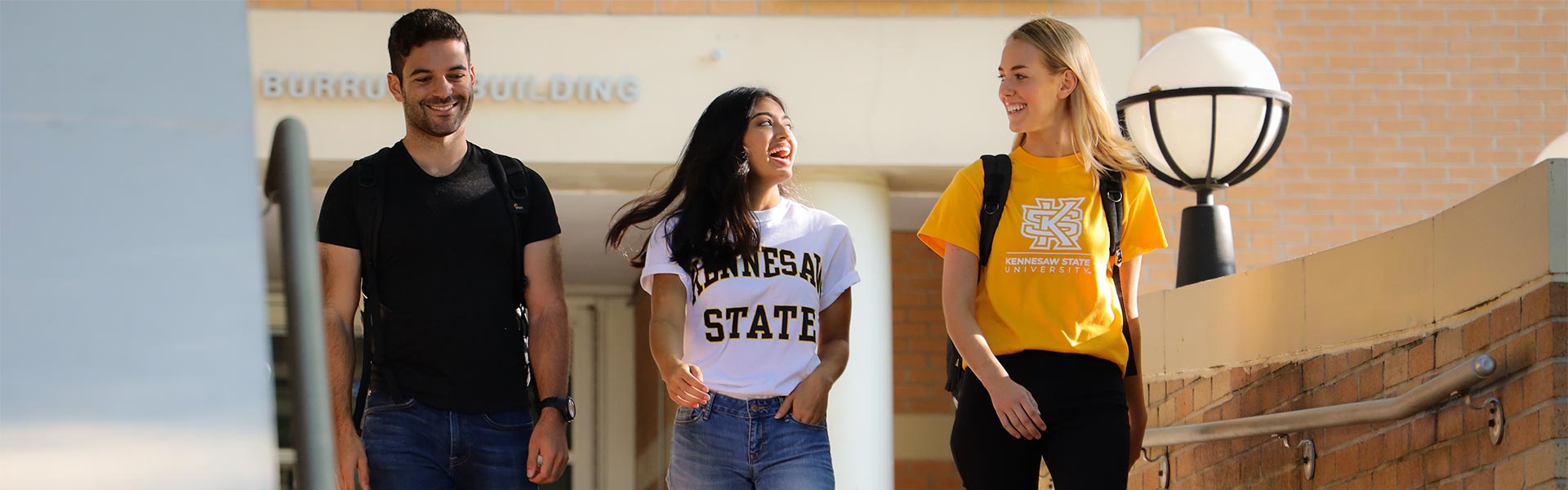 group of ksu students talking and leaving the burruss building on campus.