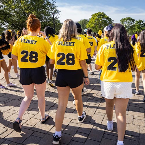 First flight students walking on campus.