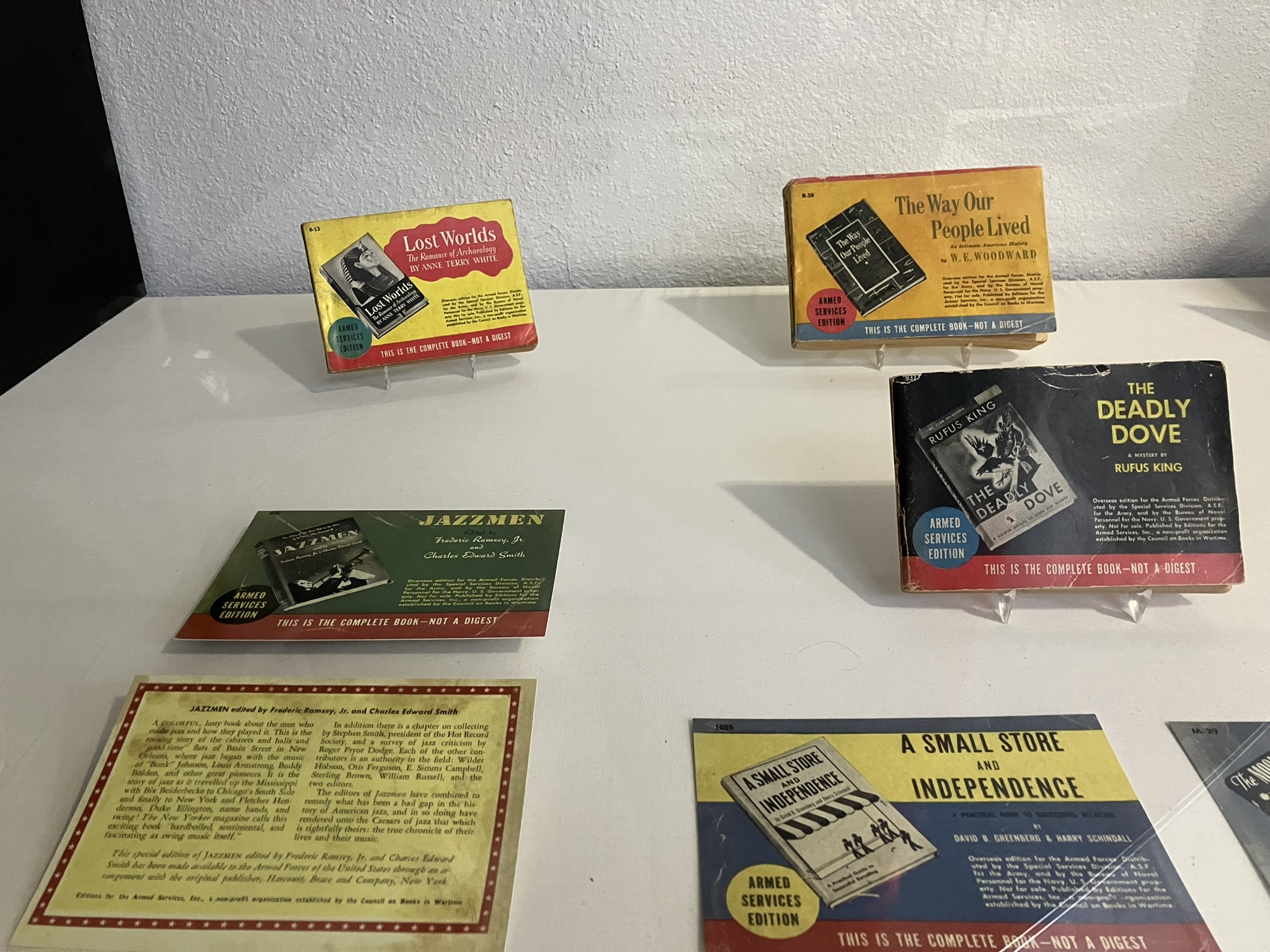 A close up of the spotlight cases showing various books, newspaper clippings and flyers from WWII