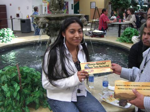 Young Maya American holding a highway safety slogan