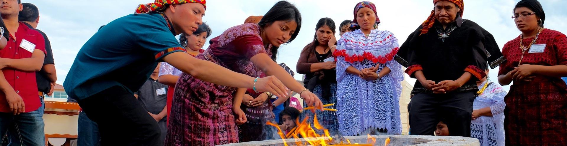 a group of Mayan women around a fire