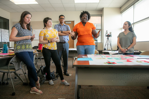 Graduate students present of a grantor about a project in the area of community mental health