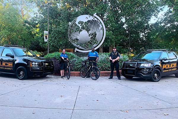 3 police officers and their vehicles on marietta campus