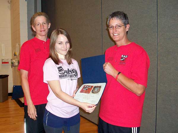 student accepting award with teachers