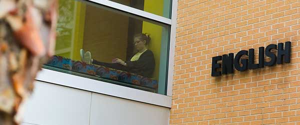 english student in window of english building