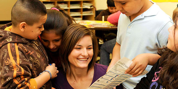 woman smiling with classmates in the  Bagwell College of Education