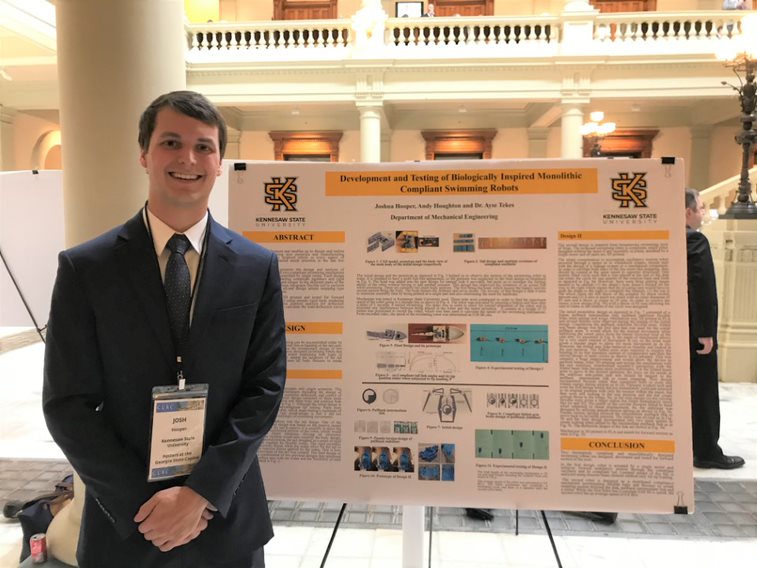 johh hooper standing in front of presenting poster 